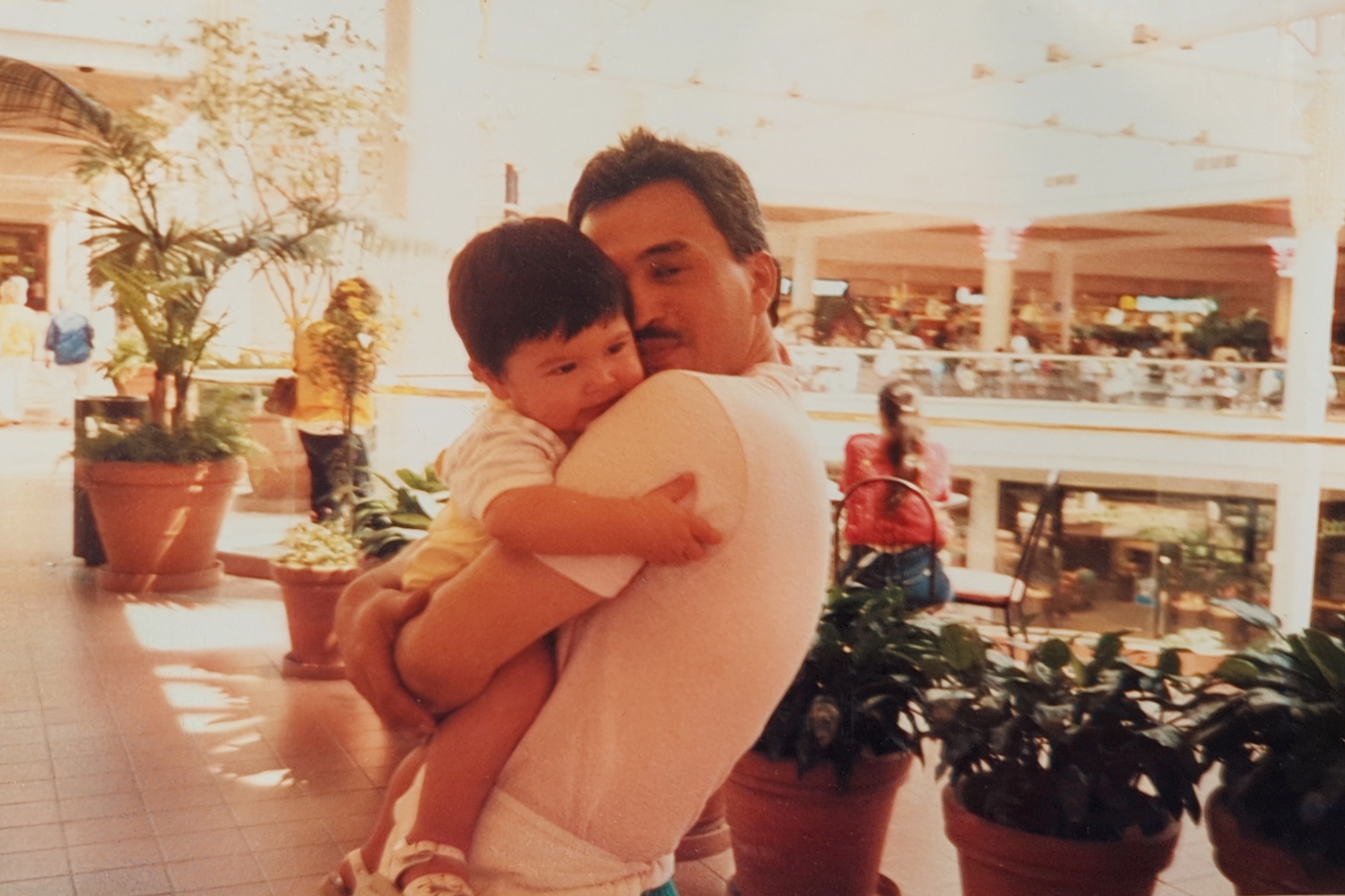 Me and Papa at the South Bay Galleria c. 1988. I'm less than 2 years old and Papa is embracing me close in his arms.